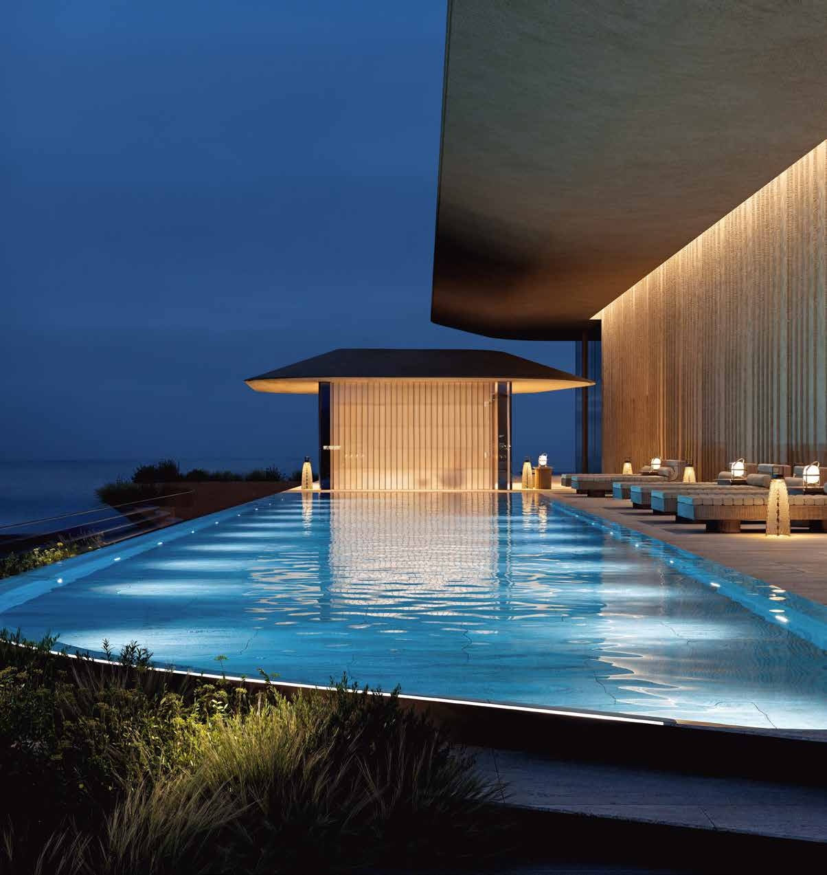 Illuminated rooftop lap pool at Wedyan